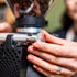 Person adjusting a coffee grinder with a blurred background